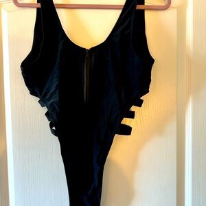 Black, high cut bathing suit with open sides detail
